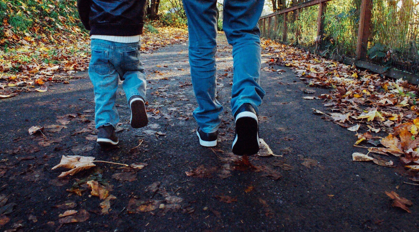 View of child & adult walking together